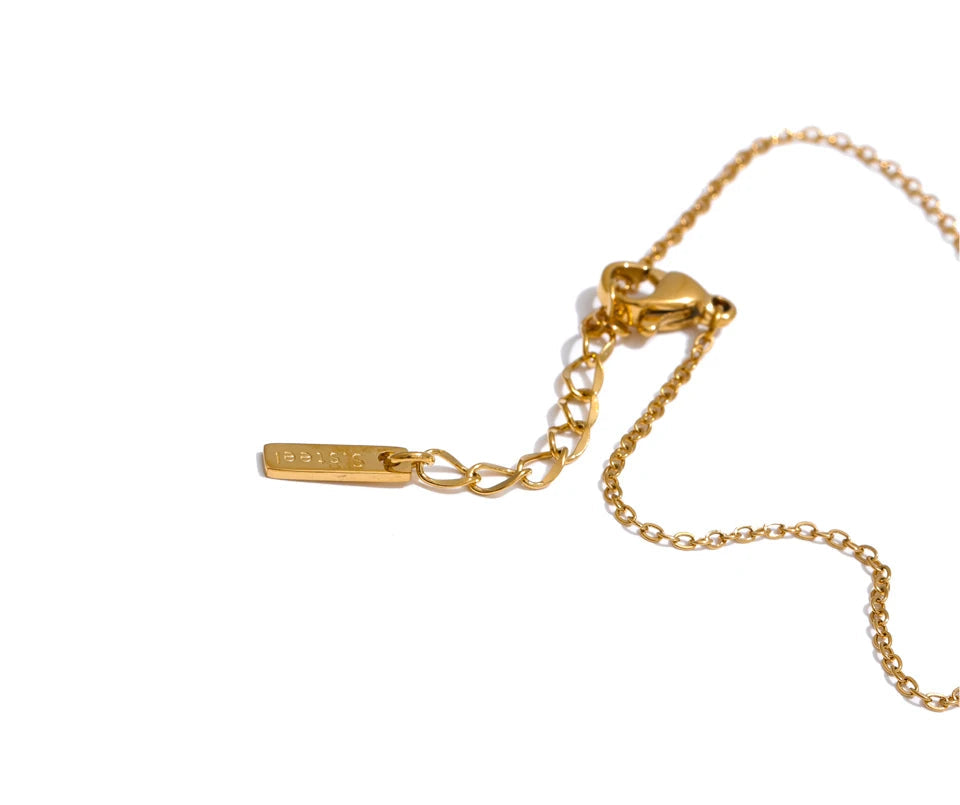 Macro of gold plated links on bracelet chain joined to hand chain loop