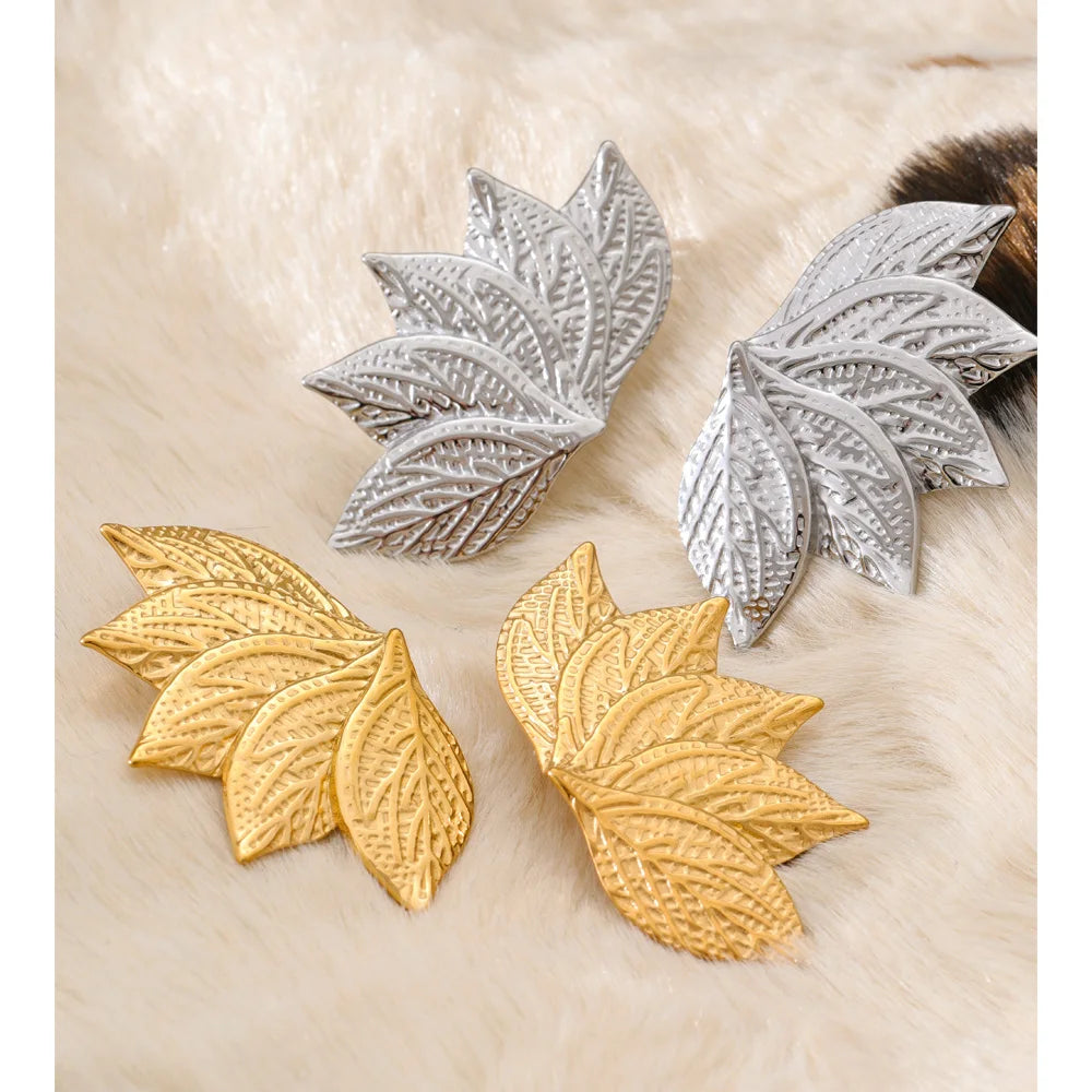 Close up of vintage inspired gold earrings with leaf detail