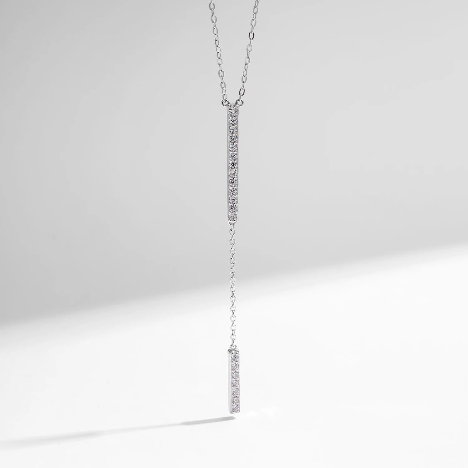 Necklace and necklace layering using a slim lariat long chain design