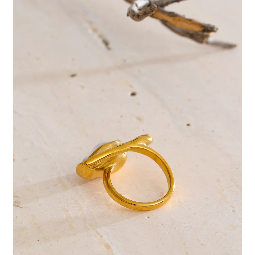 Golden golden ring featuring textured pearl design