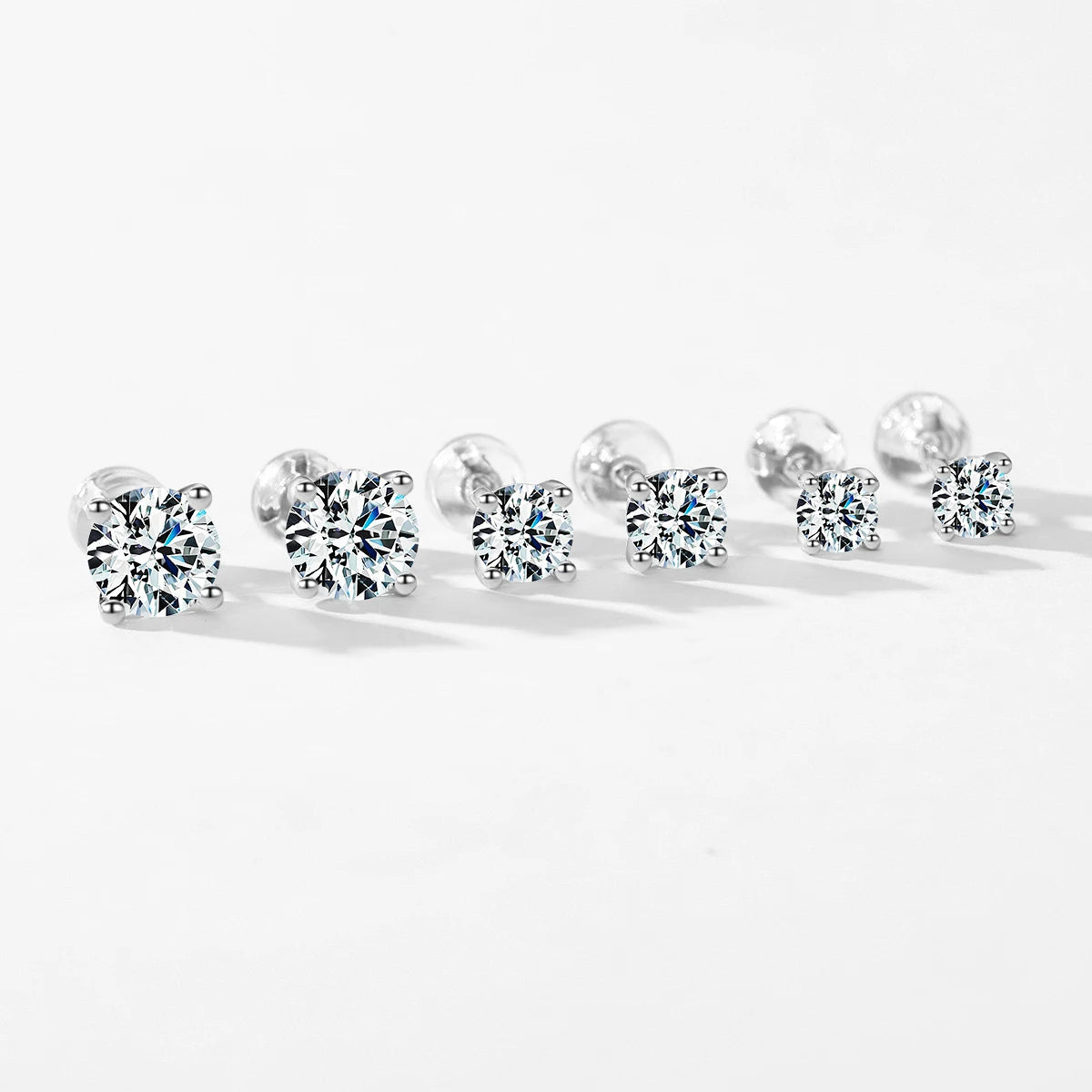 Silver earrings arranged with moissanite jewelry for coordinated style