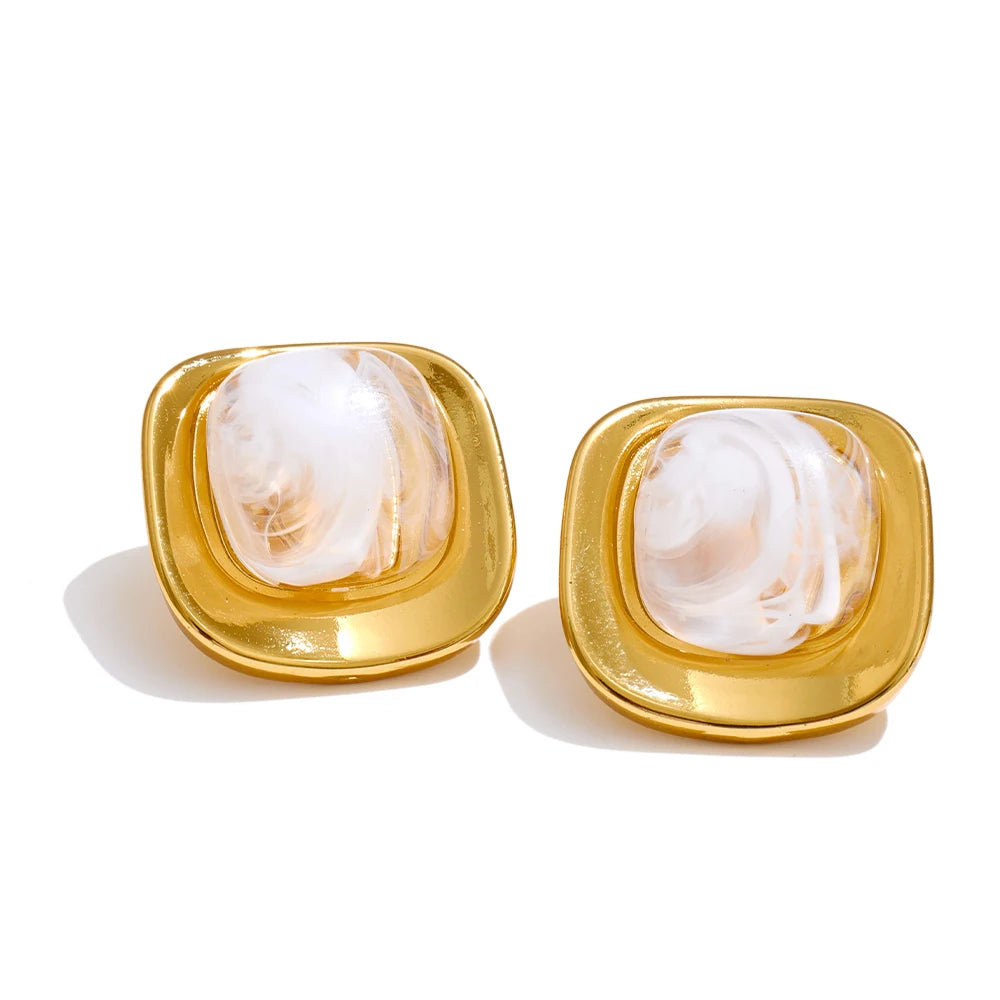 A gold earrings pair featuring white green resin squares