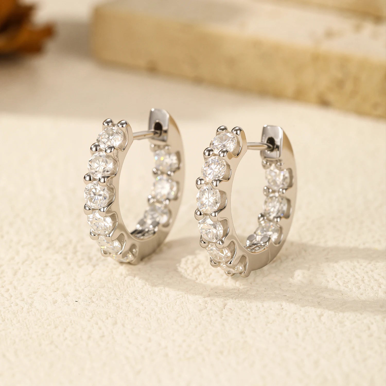Close view of moissanite jewelry set on sterling silver hoop earrings