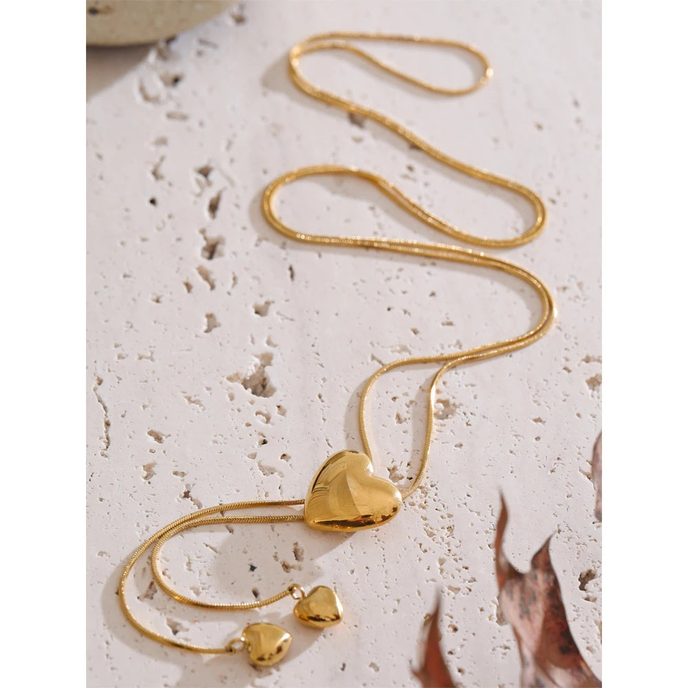 Close-up of necklace heart pendant on gold plated chain