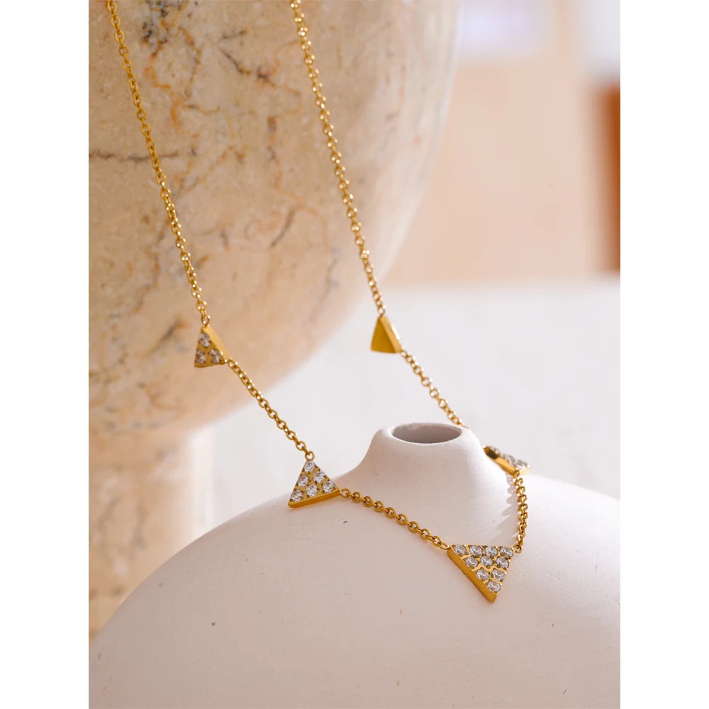 Close view of necklace pendant showing cubic zirconia sparkle with necklace with gold shine