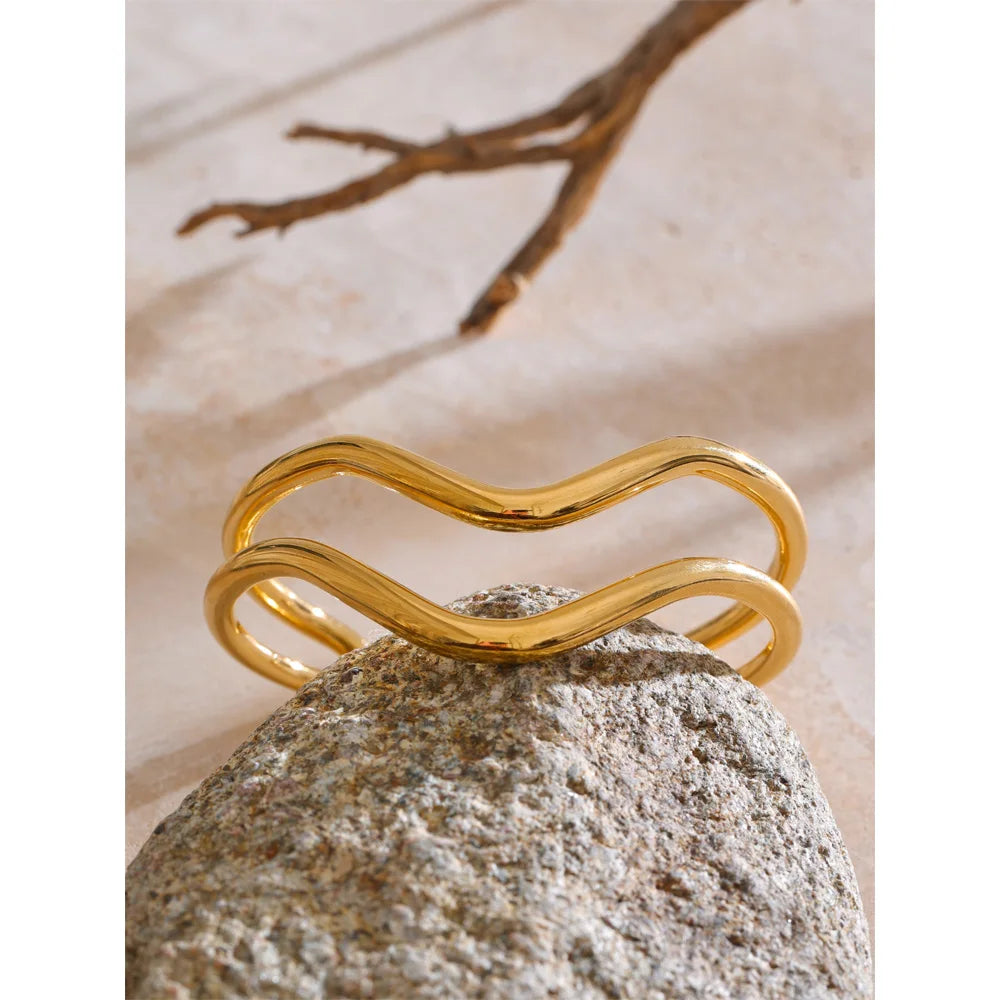 Wrist shot of waterproof jewelry bracelet layered with bracelet bracelets