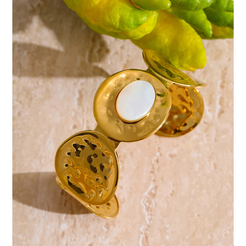 Polished stainless steel jewelry cuff with organic shell-inspired texture