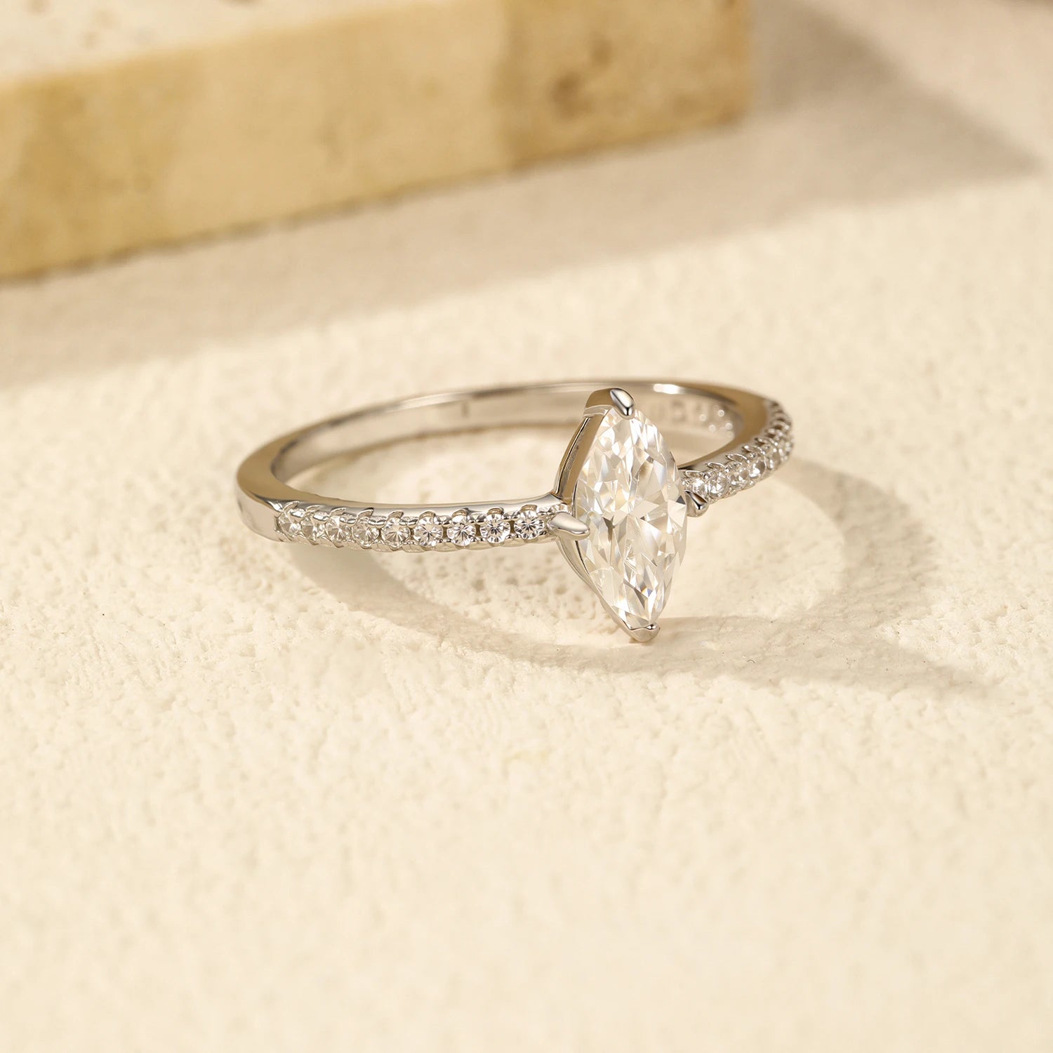Refined engagement ring set next to moissanite jewelry rings