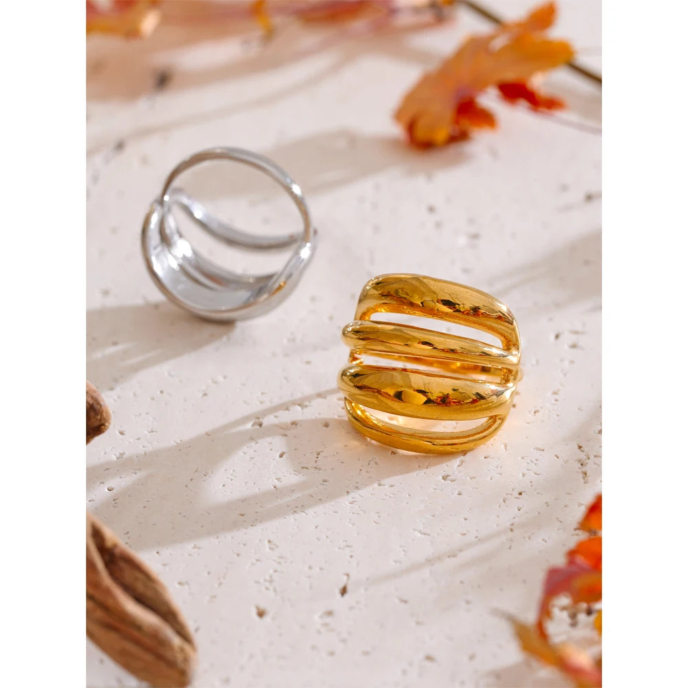 Close up of gold plated finger with a ring showing modern geometric lines