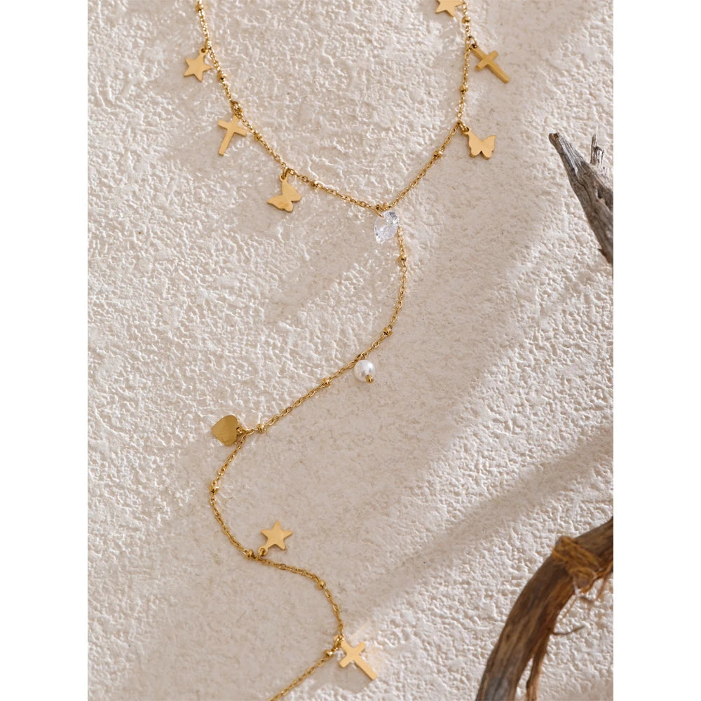 Long Y chain necklace featuring butterfly charm and elegant pearl drop