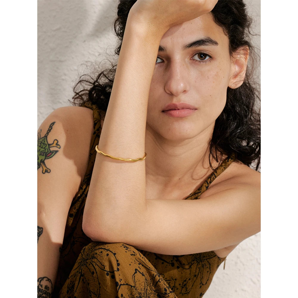 Close view of stainless steel bracelet with gold bracelet glow and hammered texture