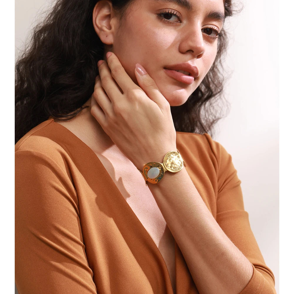 Gold bangle and gold bracelet styling with wide hammered cuff on wrist