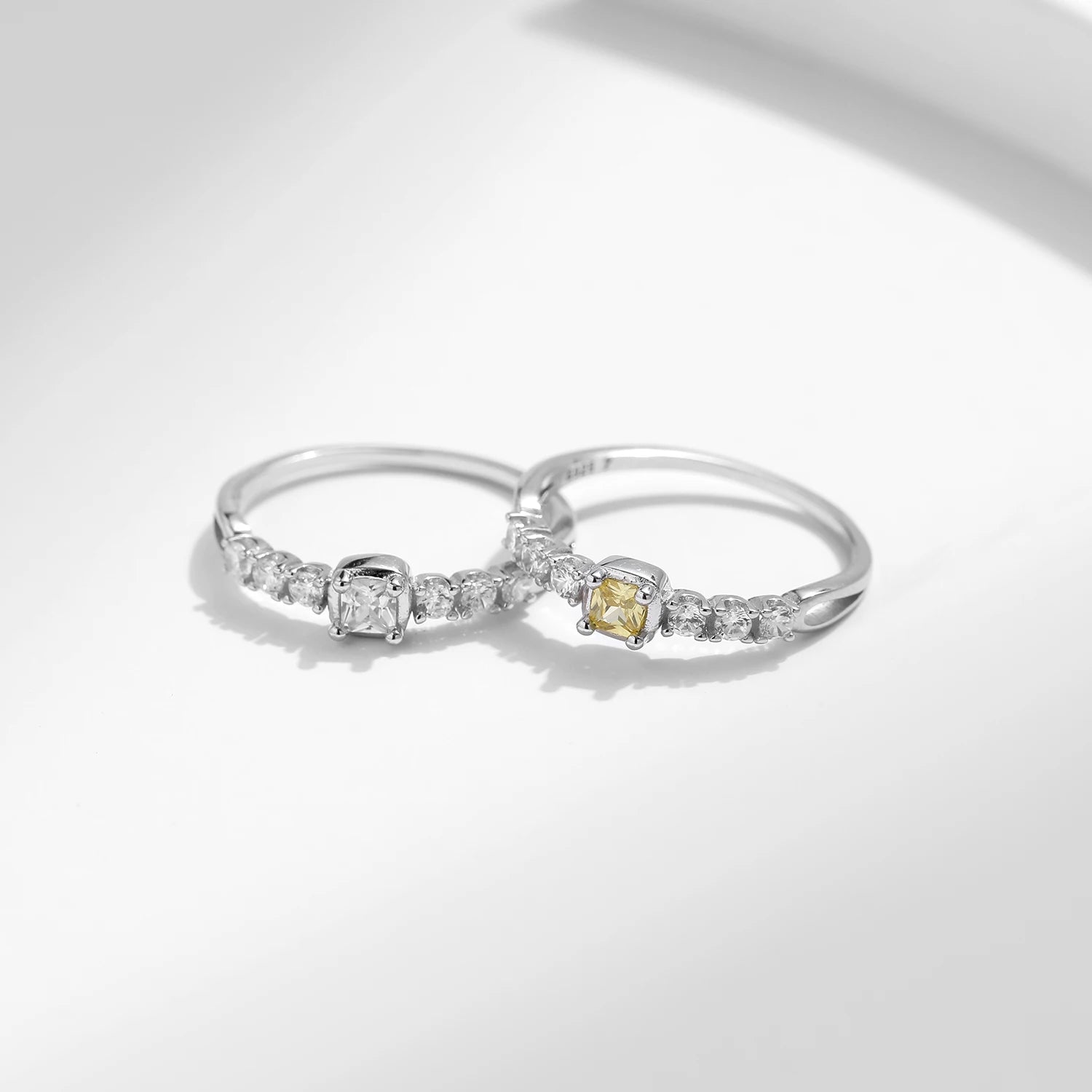 Stacked silver rings featuring a luminous cubic zirconia ring