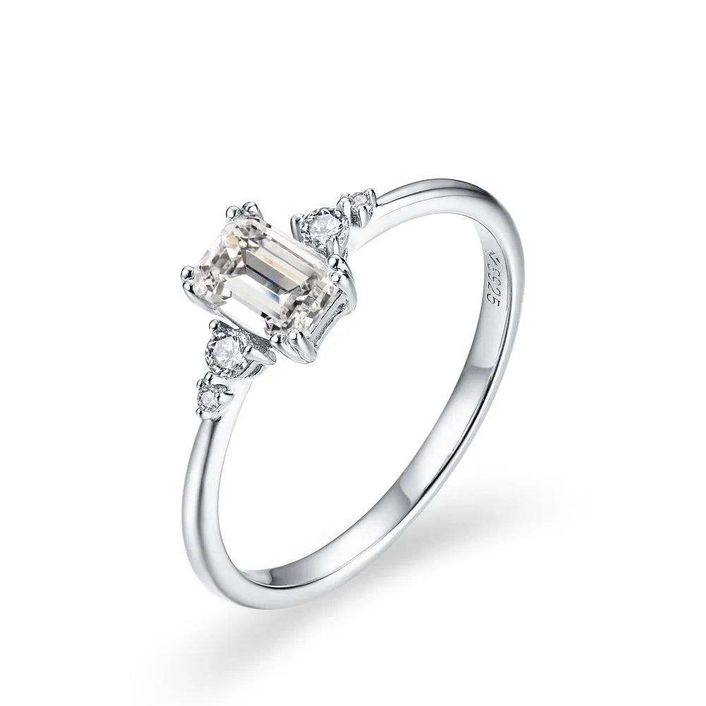 Rings with moissanite styled around an emerald cut engagement ring