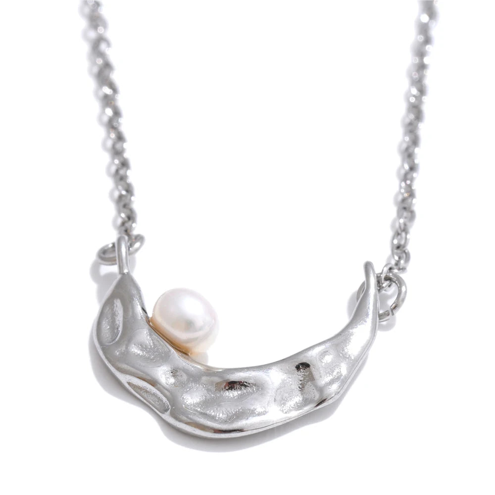 Fashion shot of pearl on necklace paired with necklace golden necklace