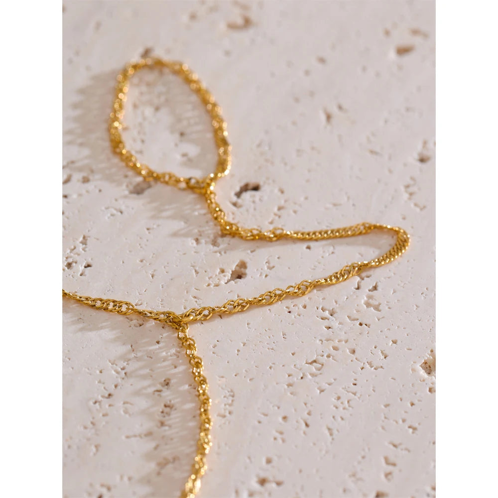 Hand display of bracelet chain flowing to a finger for rings accent with ring chain grace