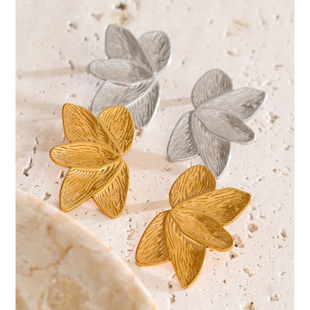 Women wearing gold earrings with flower design accessory