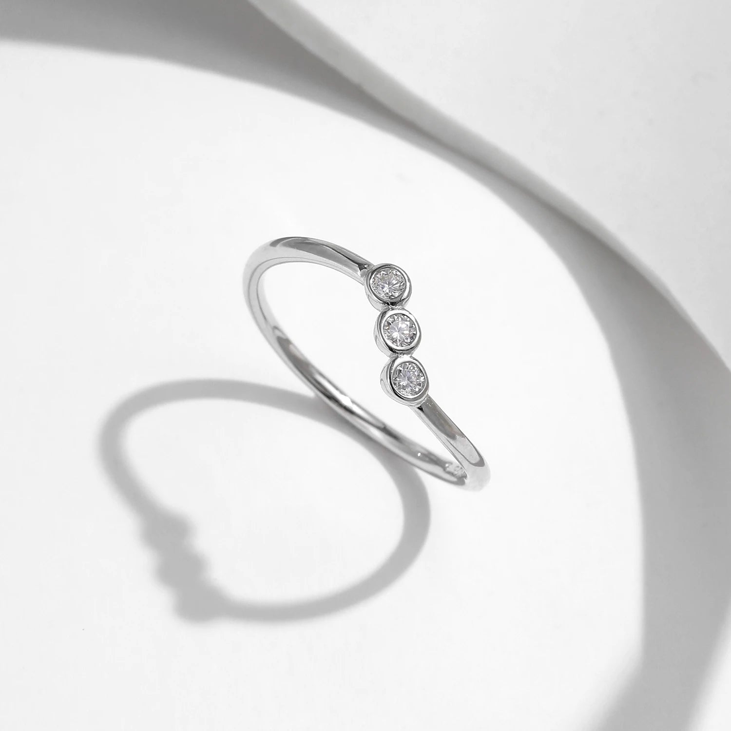 Rings with moissanite beside a sterling silver ring