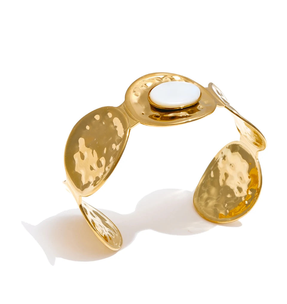 Side view of gold plated shell textured cuff showing depth and polish