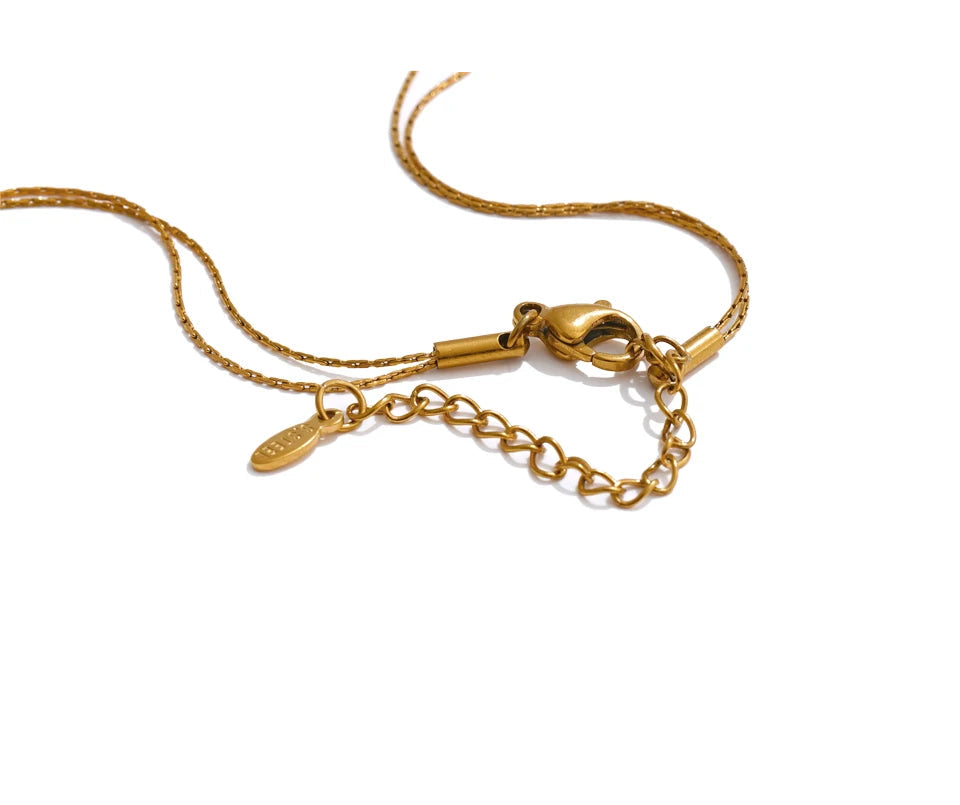 Soft light macro of necklace pendant texture on gold plated chain