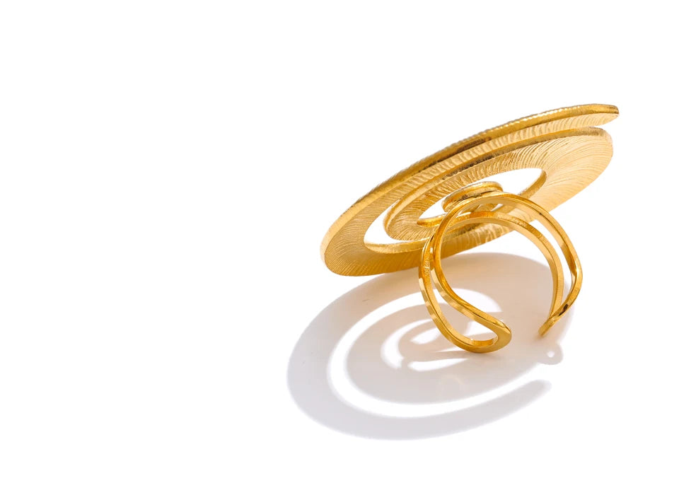 Statement open ring showing interior curve and polished gold tone