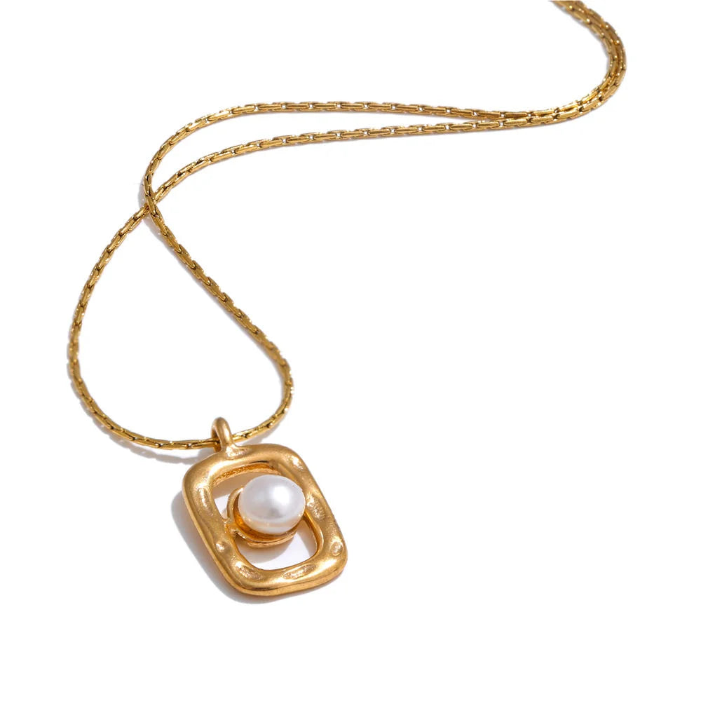 Close up of pearl with necklace in rectangular golden setting
