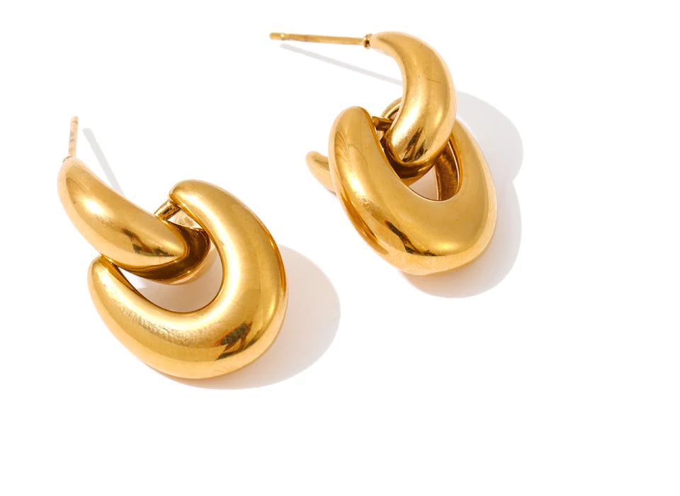 Gold women earrings featuring modern U shaped silhouette