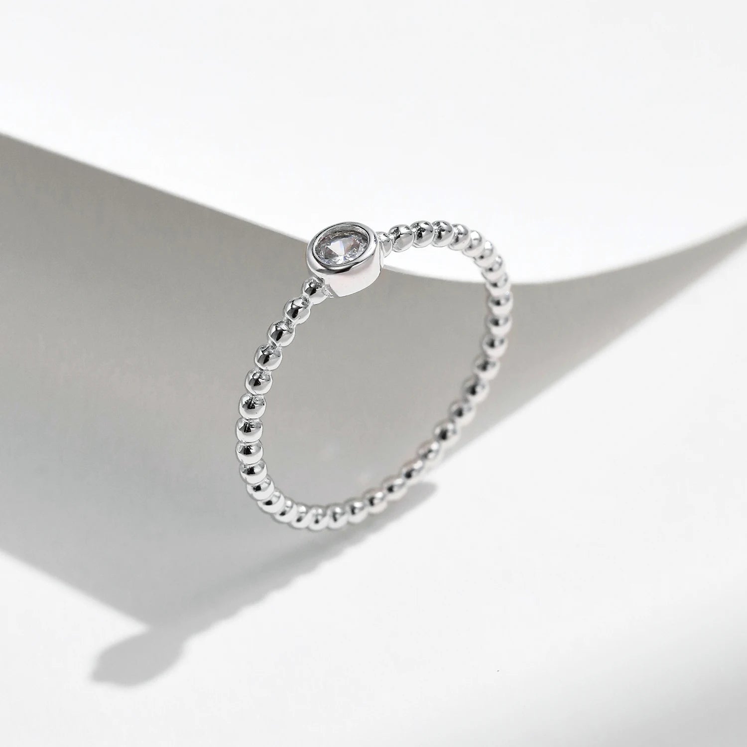 Moissanite diamonds bezel ring paired with a minimal silver ring