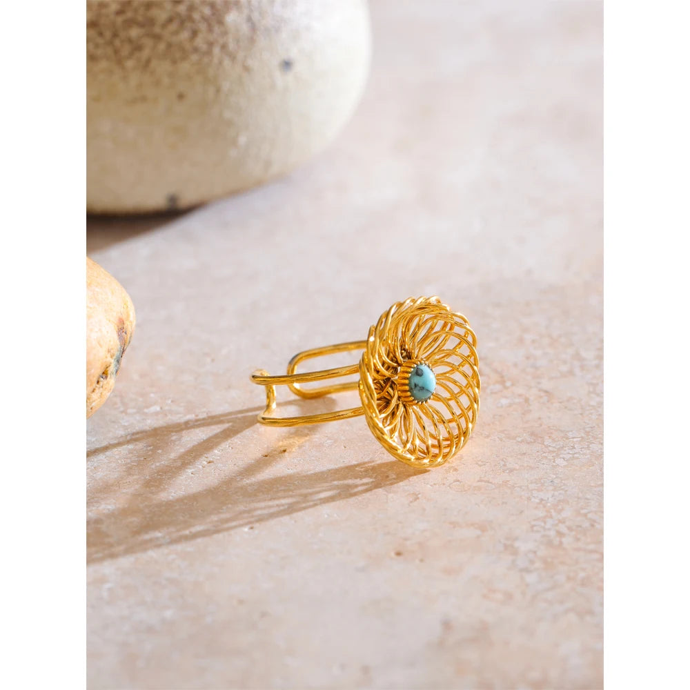 Close-up of flower ring showing natural stone centre and textured petals in gold tone