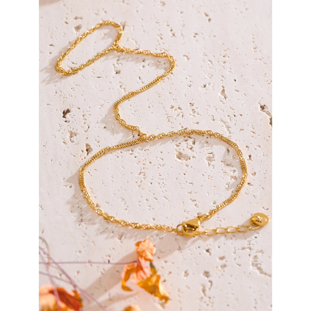 Side angle showing link ring detail on stainless steel jewelry with smooth finish