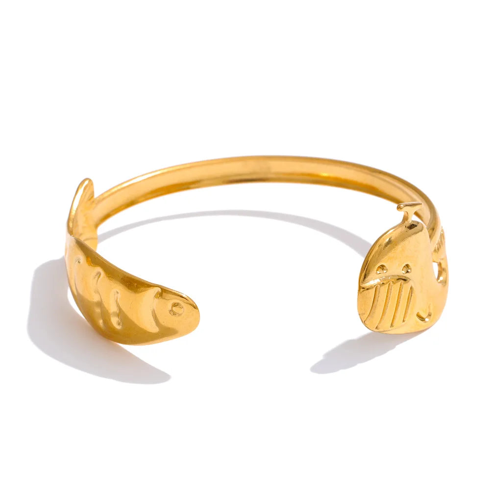 Clean bangle and bracelet stack anchored by a gold bracelet bangle