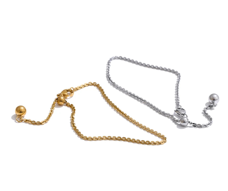 Wrist view of bracelet charm bracelet layered with chain bracelet accents