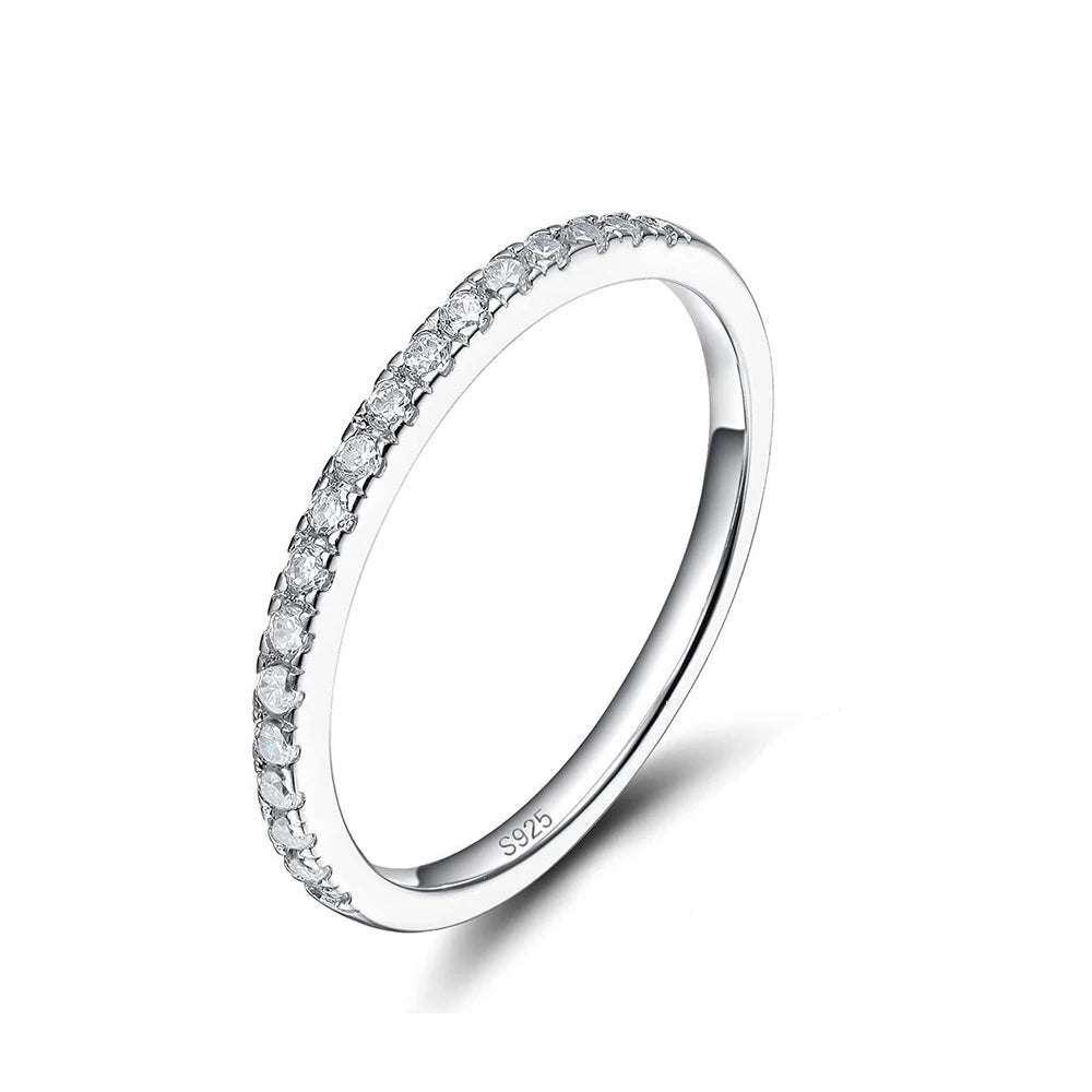 A white gold ring with a band of round-cut moissanite stones.