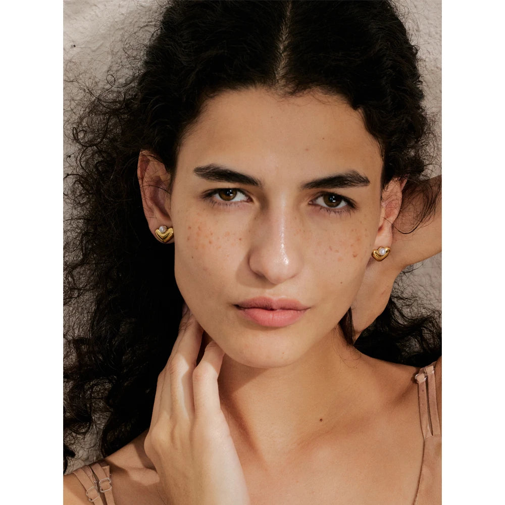 Close view of stud earrings as ear rings with glossy pearl and a gold earrings finishClose view of stud earrings as ear rings with glossy pearl and a gold earrings finish