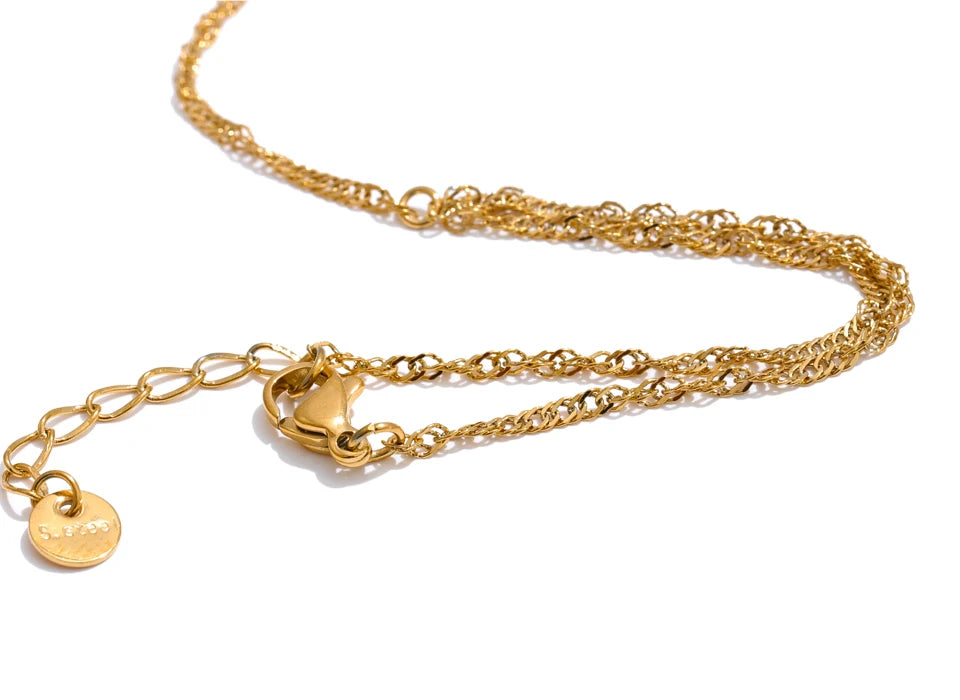 Polished bracelet bangle in gold beside link ring connector for refined bracelet bracelets