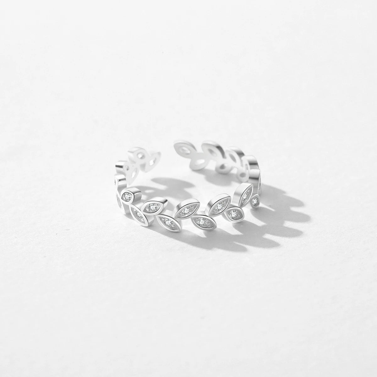 Minimal sterling silver ring styled beside an earrings ring