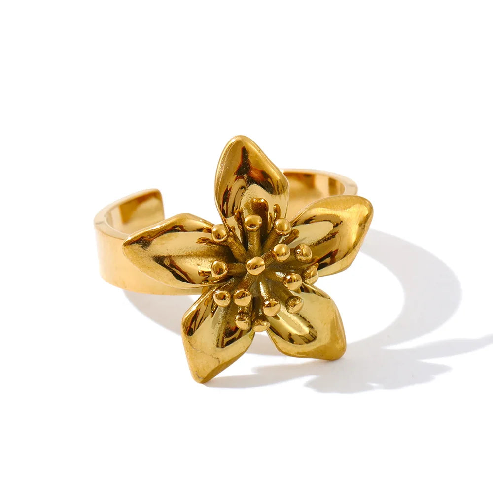 Macro detail of stainless steel jewelry floral texture on earrings gold earrings