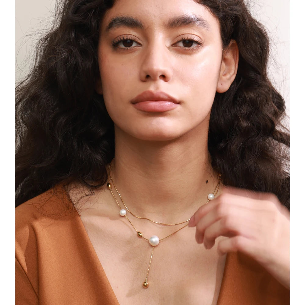 Pearl for necklace beads arranged along layered chains