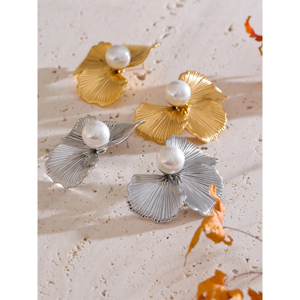 Minimal studio shot of a gold a earrings look featuring a soft floral silhouette