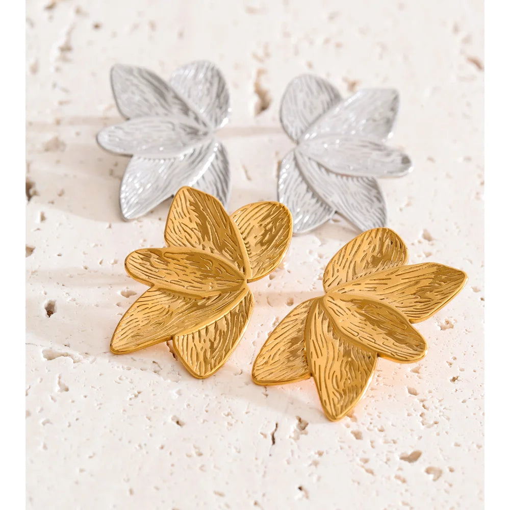 Close up of floral metal earrings gold plated jewelry detail