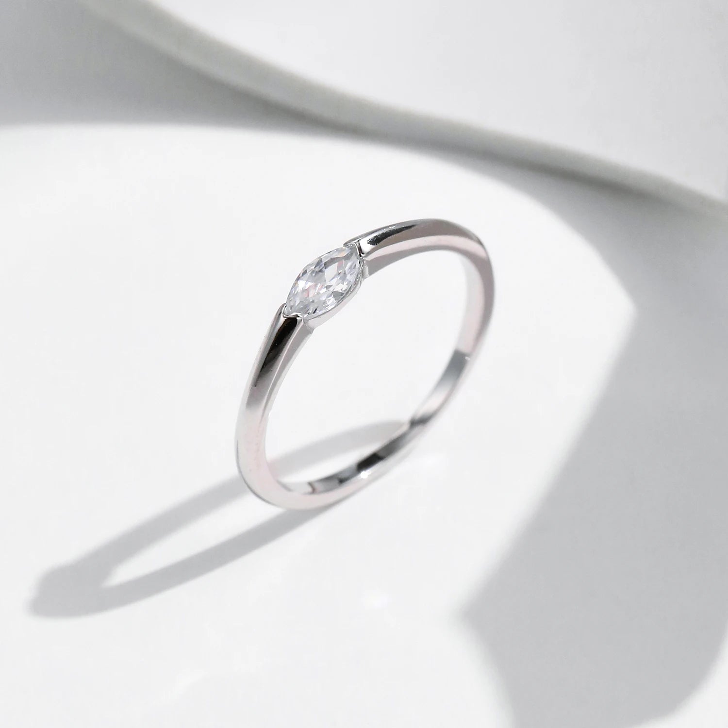 Close view of marquise cut CZ wedding ring and wedding band pairing