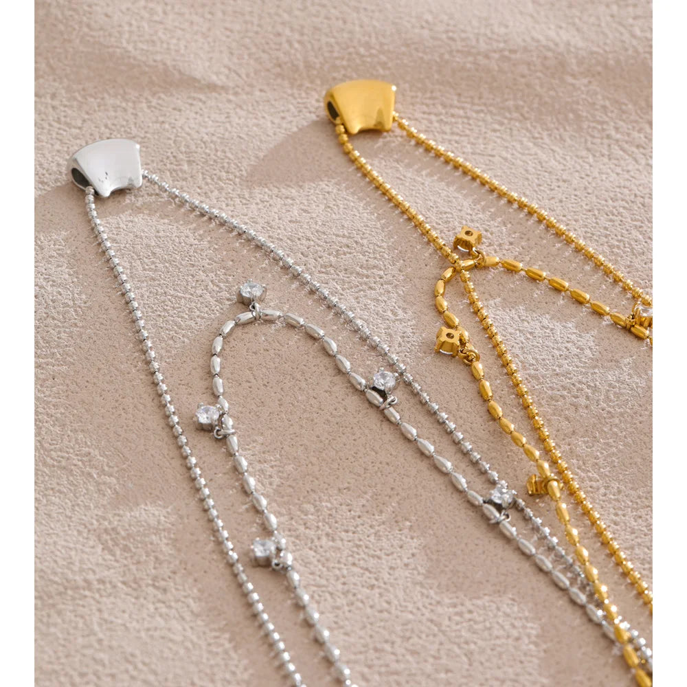 Layer necklace silhouette featuring cubic zirconia drop