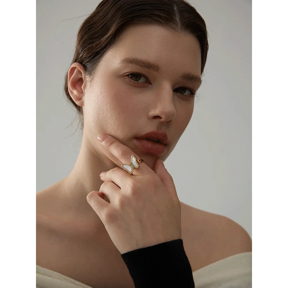 Close view of a cubic zirconia ring butterfly ring with gold and ring accents