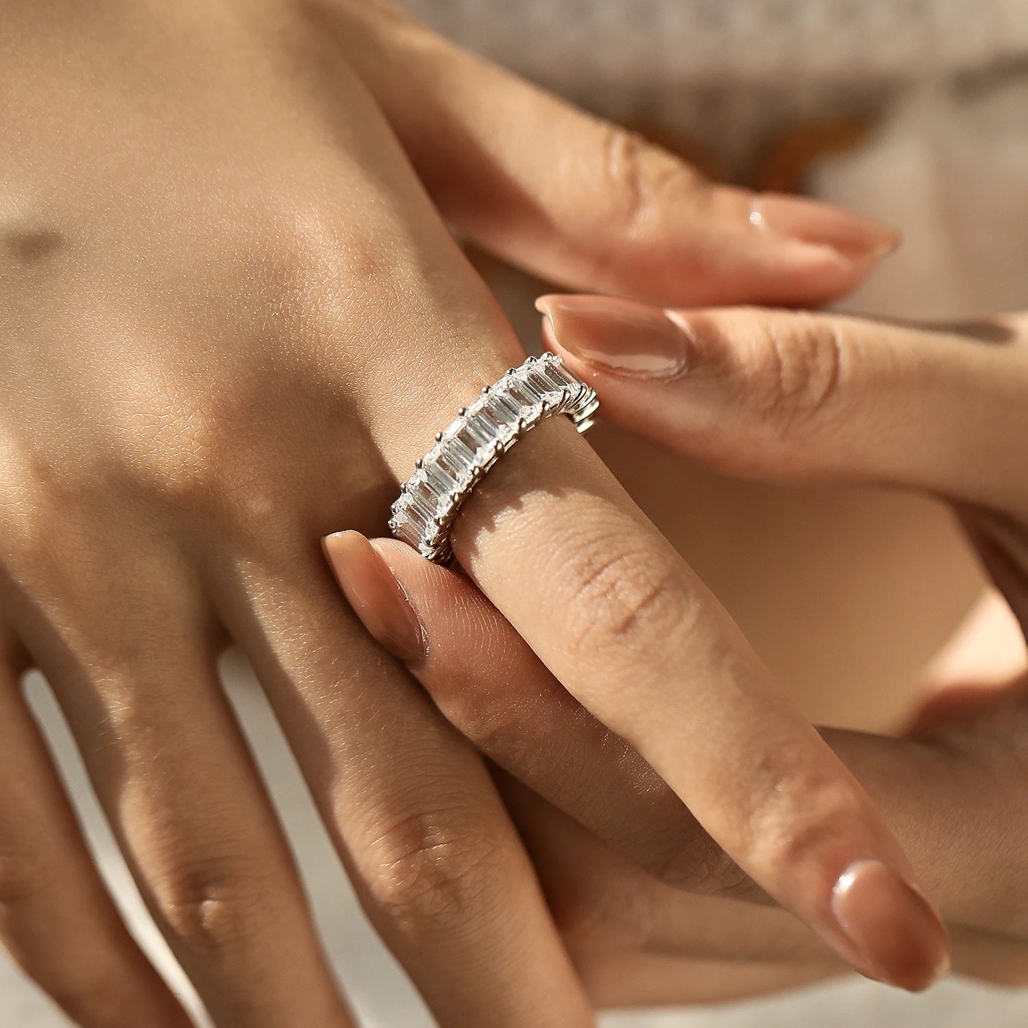 A wedding ring in eme rald style with refined zirconia brilliance