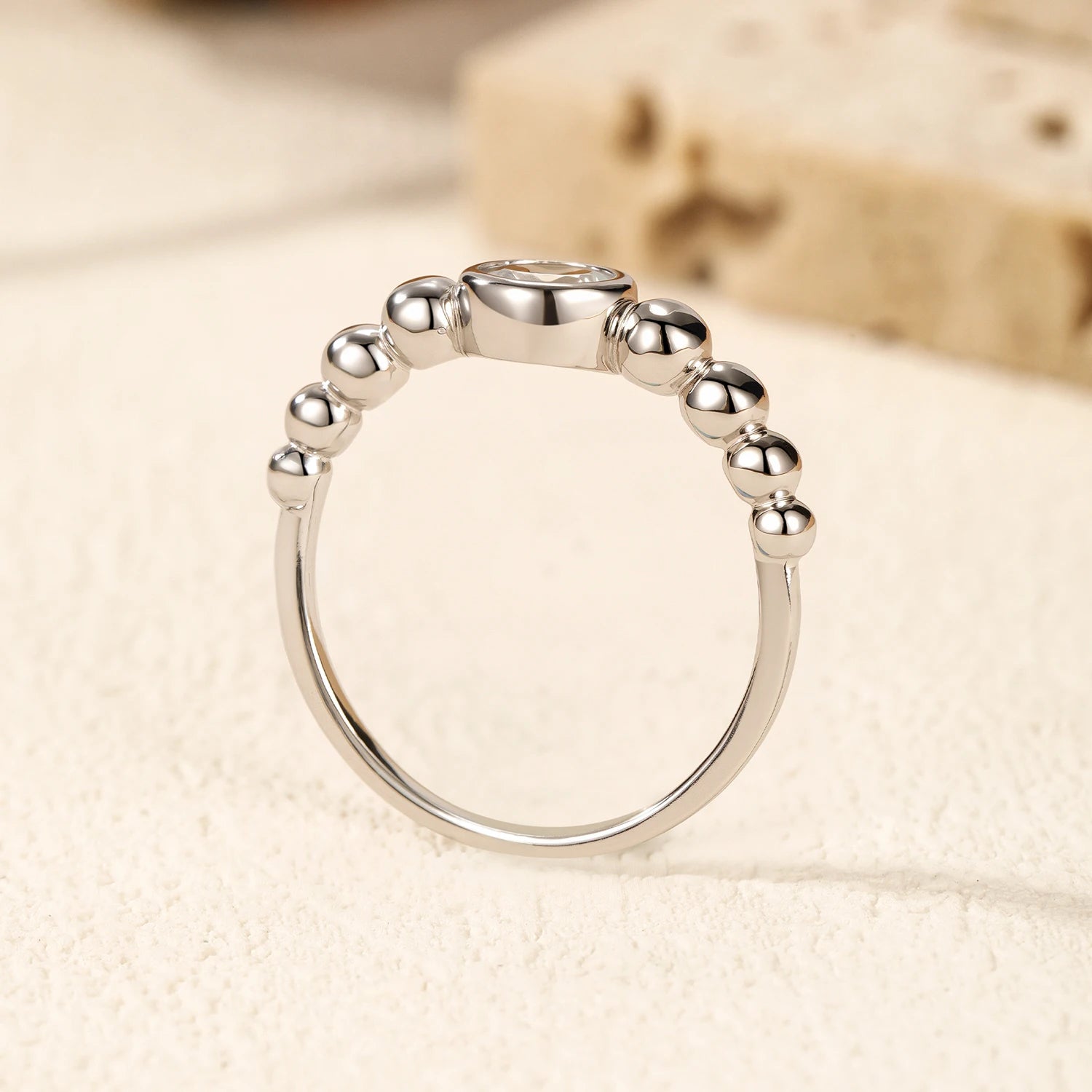 Rings with moissanite arranged beside sterling silver rings for layering