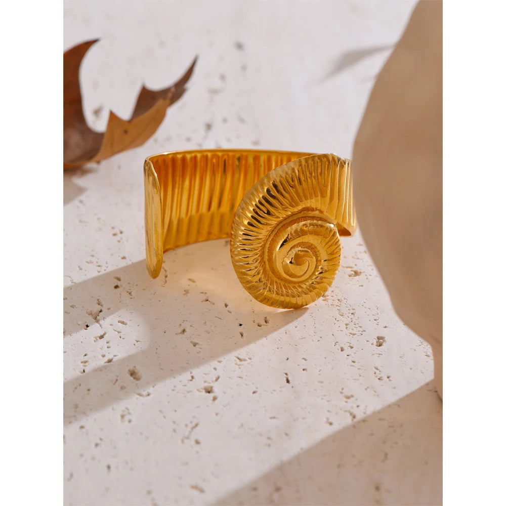 Minimal studio shot of bracelet bracelets stack with a bold gold plated cuff