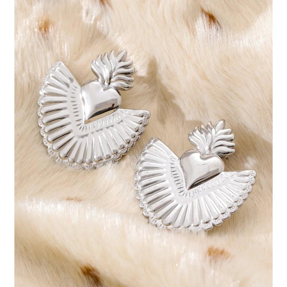 Women wearing golden jewelry heart stud earrings accessory