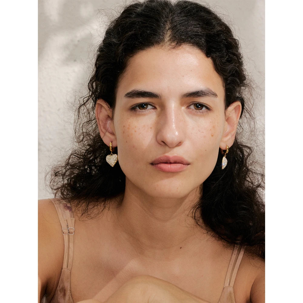 Close view of heart earrings showing cubic zirconia sparkle and earring earrings polish