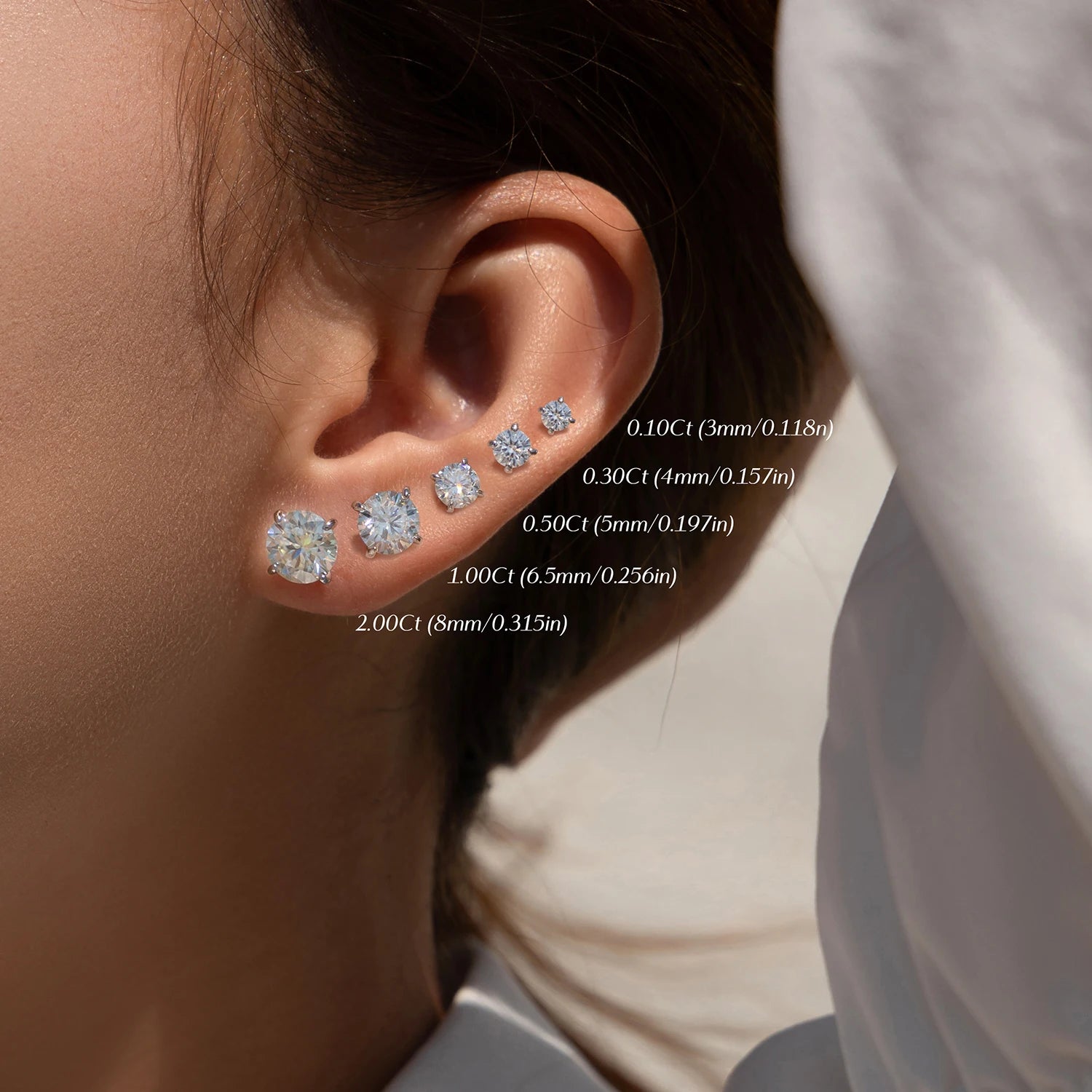 Stud earrings displayed with moissanite jewelry in a refined setting