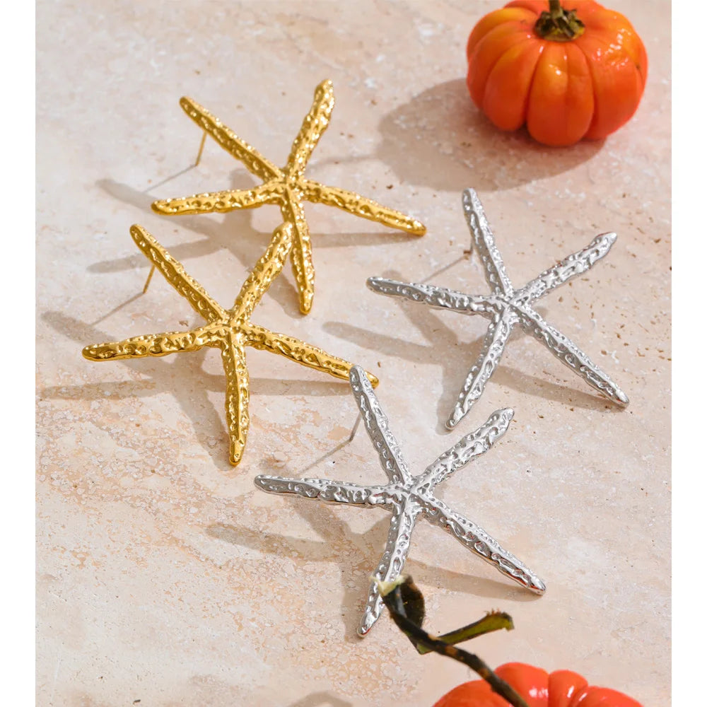Women with earrings wearing gold plated starfish studs